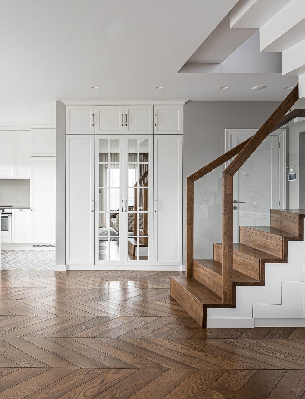 Neįpareigojanti klasika: subtilus Chevron parketo, ąžuolinių laiptų ir vidaus durų derinys